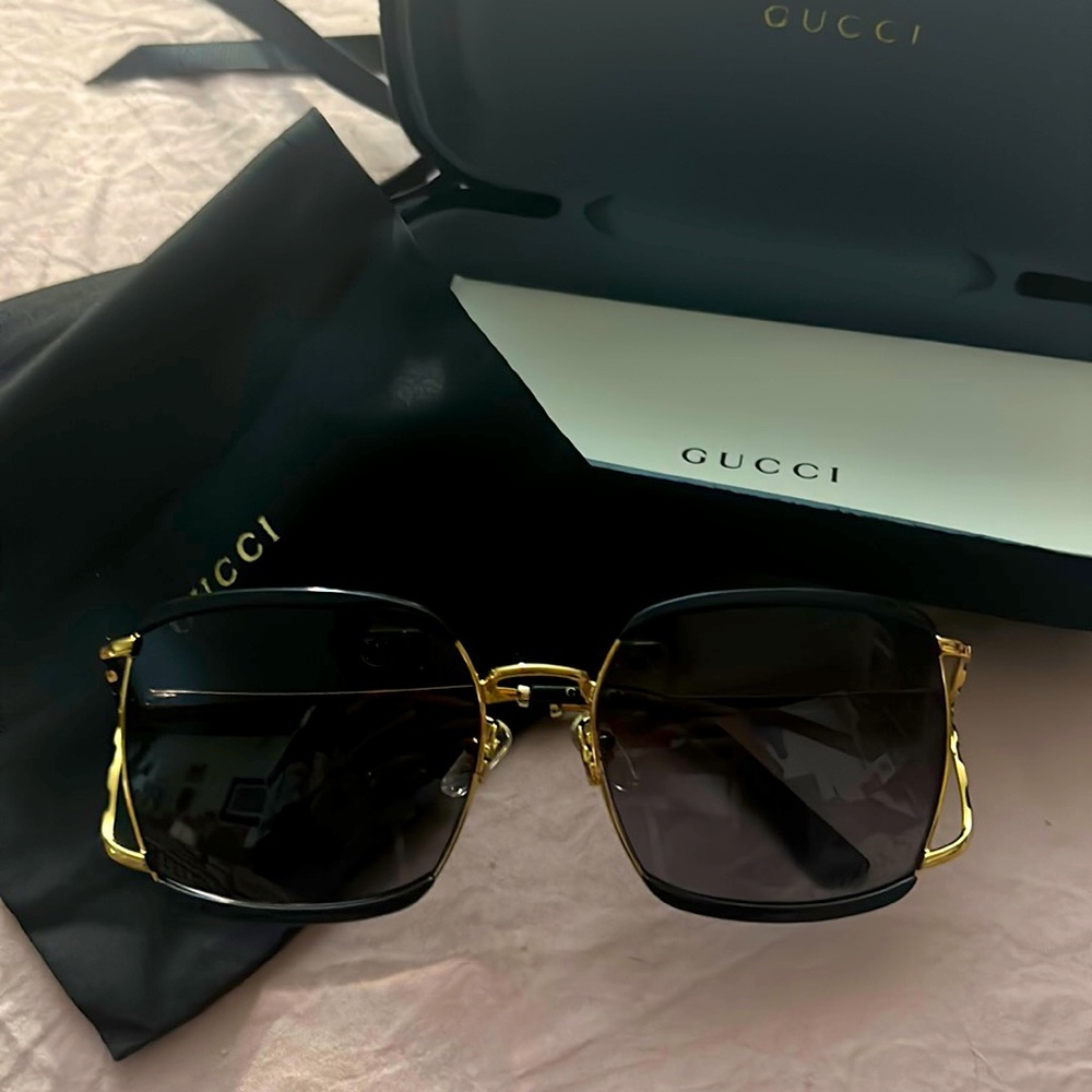 Gucci oversize newish sunglasses in black and gold.